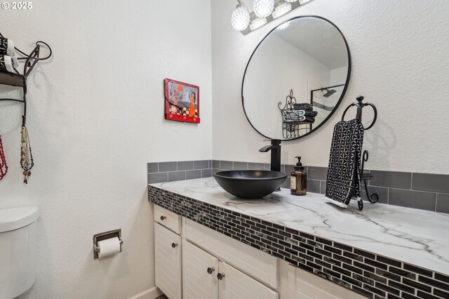 bathroom featuring toilet and vanity