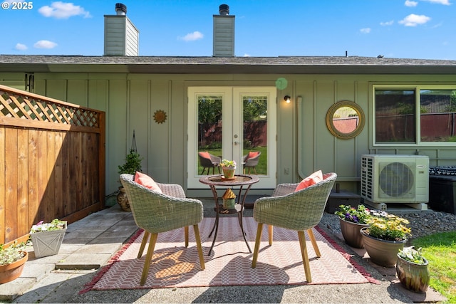 view of patio with french doors, fence, and ac unit
