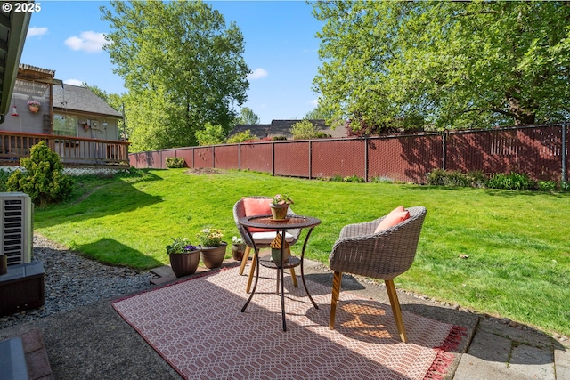 view of yard with a patio, central AC, and a fenced backyard