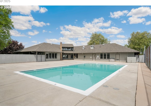 pool featuring fence and a patio area