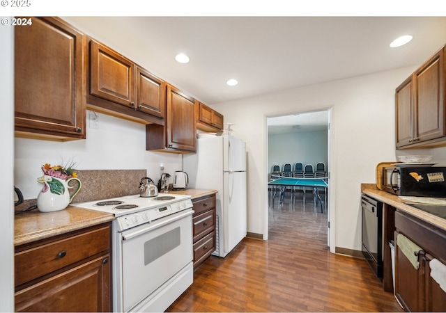 kitchen with white appliances, dark wood-style flooring, recessed lighting, and light countertops