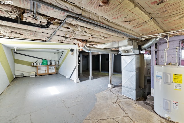 unfinished basement with electric water heater and heating unit