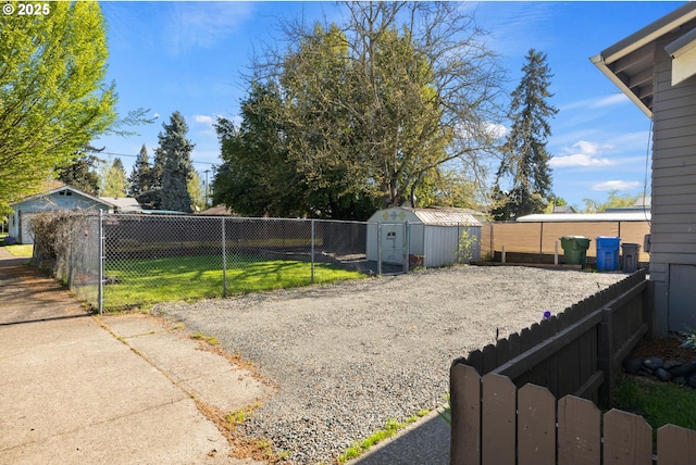 view of yard with a storage unit, an outdoor structure, and fence