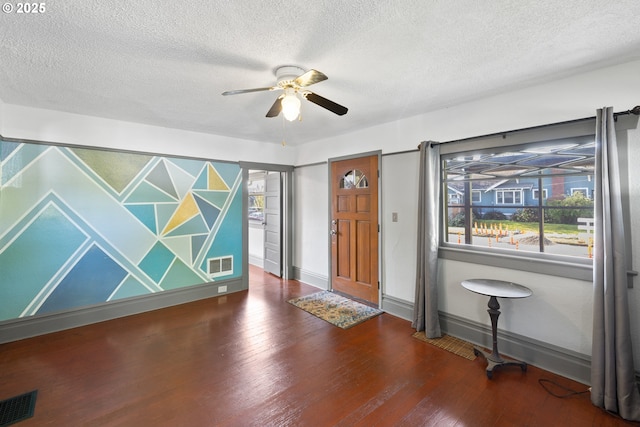 entrance foyer featuring visible vents, ceiling fan, baseboards, and wood finished floors