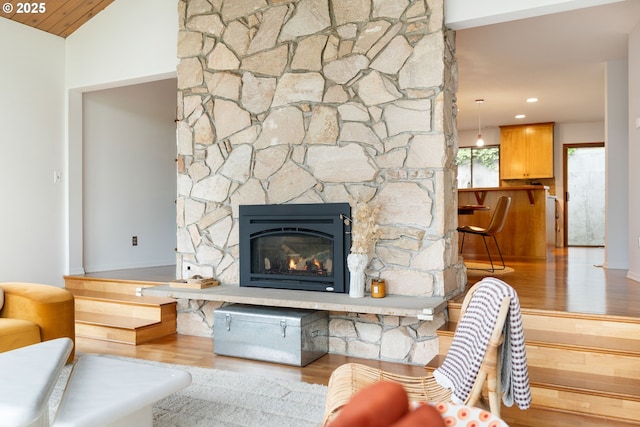 2345 NE Ridgewood Dr, Portland, OR 97212 - living area featuring wood finished floors, a stone fireplace, and lofted ceiling