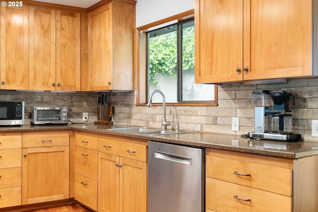 2345 NE Ridgewood Dr, Portland, OR 97212 - kitchen featuring stainless steel appliances, a sink, decorative backsplash, and dark stone counters