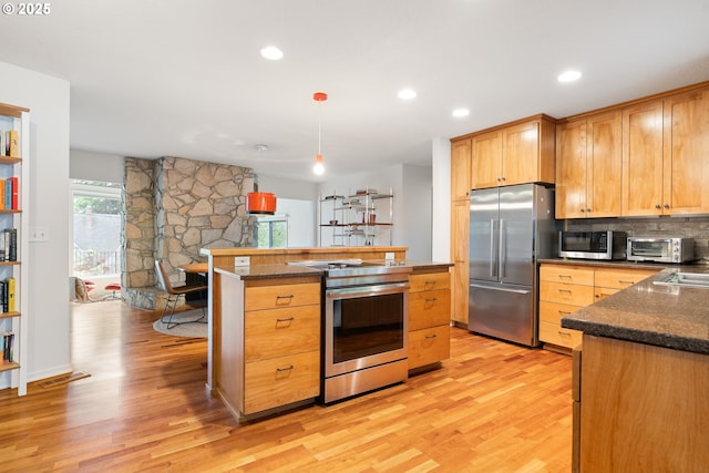 2345 NE Ridgewood Dr, Portland, OR 97212 - kitchen with stainless steel appliances, light wood-style flooring, dark stone counters, and recessed lighting