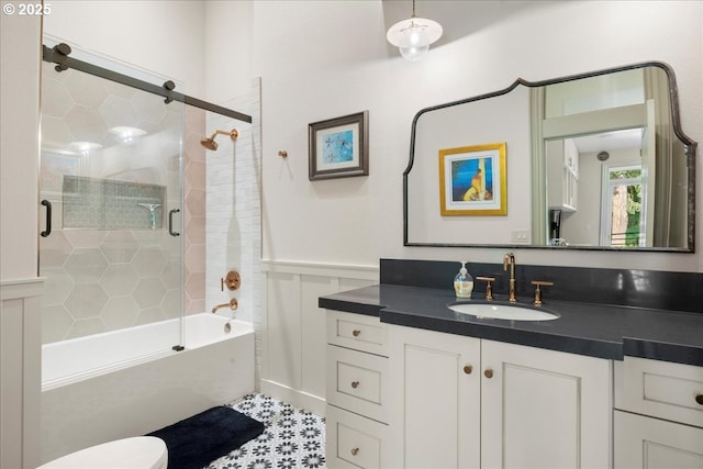 25003 NW 4th Ct, Ridgefield, WA 98642 - bathroom featuring vanity, bath / shower combo with glass door, and a wainscoted wall