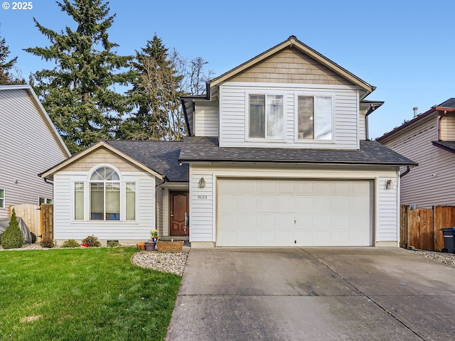 traditional home with an attached garage, a shingled roof, fence, concrete driveway, and a front lawn