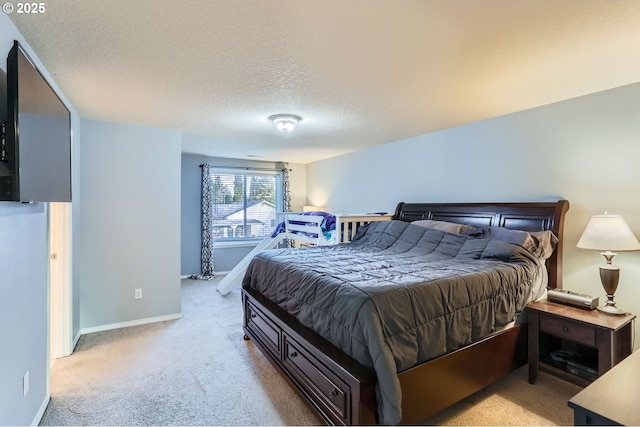 bedroom with a textured ceiling, baseboards, and carpet flooring