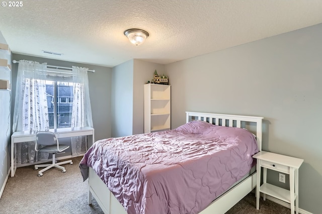 bedroom featuring a textured ceiling, visible vents, and carpet flooring