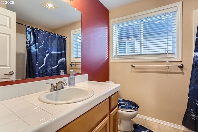 full bath with a shower with shower curtain, toilet, vanity, tile patterned flooring, and baseboards