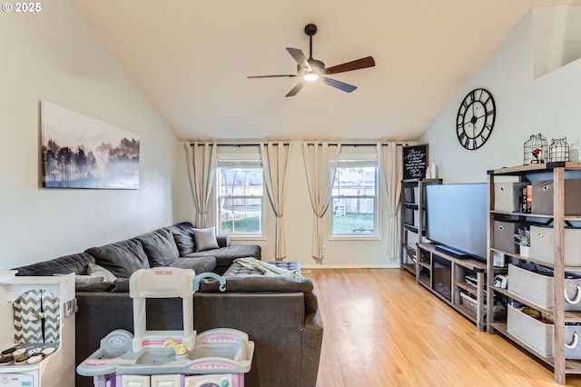 living room featuring a ceiling fan, vaulted ceiling, and wood finished floors