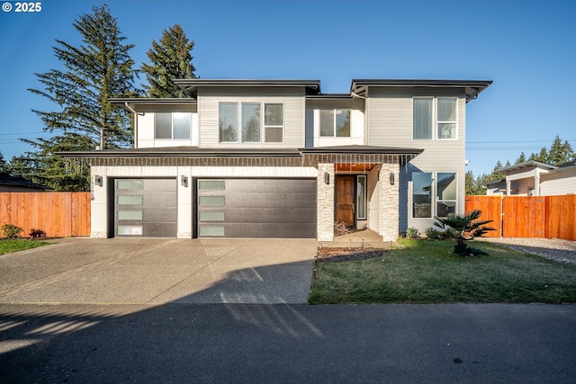 view of front of property with concrete driveway, an attached garage, and fence