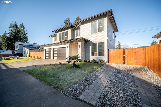 view of front of house featuring an attached garage, concrete driveway, and fence