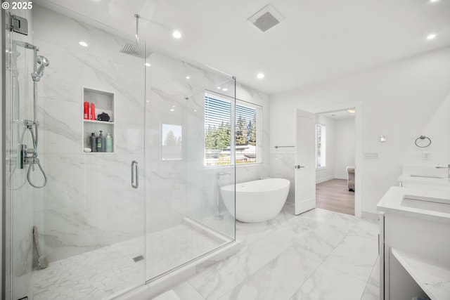 full bathroom with a marble finish shower, visible vents, recessed lighting, a freestanding tub, and marble finish floor