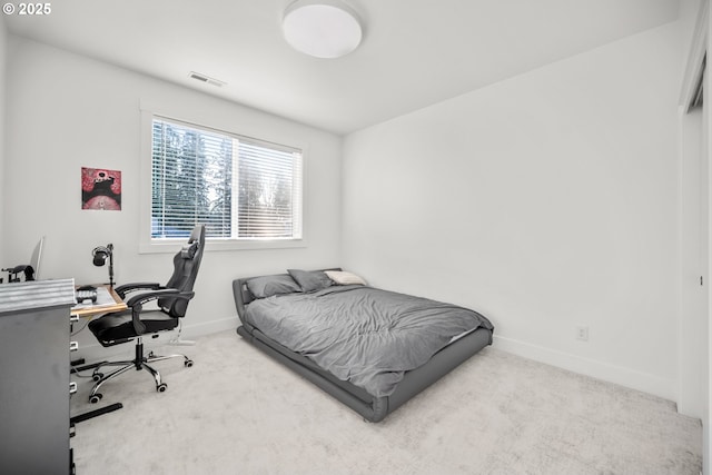 carpeted bedroom with visible vents and baseboards