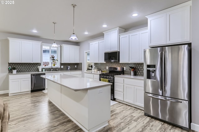 12024 NE 109th St, Vancouver, WA 98662 - kitchen with white cabinetry, light countertops, appliances with stainless steel finishes, and light wood-style flooring