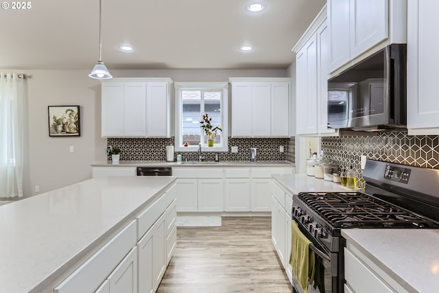 12024 NE 109th St, Vancouver, WA 98662 - kitchen with hanging light fixtures, light countertops, white cabinets, and stainless steel appliances