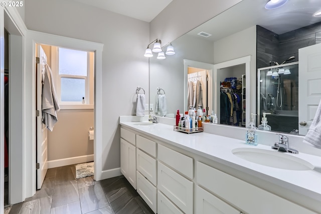 12024 NE 109th St, Vancouver, WA 98662 - full bathroom featuring a shower stall, double vanity, a spacious closet, and a sink