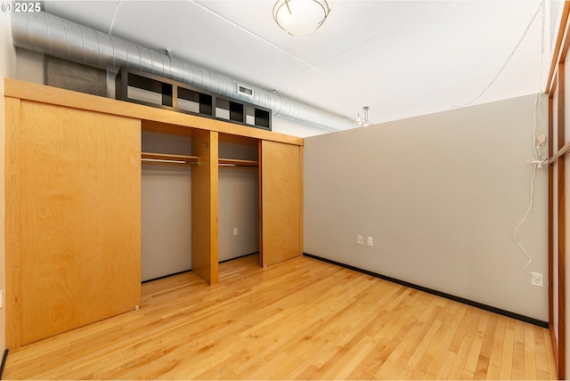 333 NW 9th Ave Unit 902, Portland, OR 97209 - unfurnished bedroom featuring wood finished floors and a closet