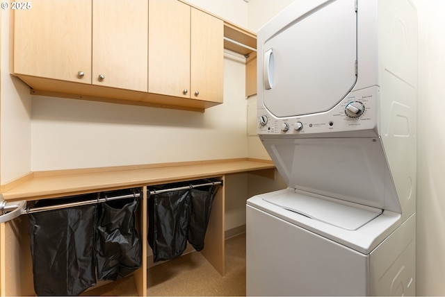 333 NW 9th Ave Unit 902, Portland, OR 97209 - washroom with stacked washer / dryer and cabinet space