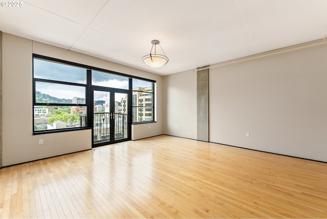 333 NW 9th Ave Unit 902, Portland, OR 97209 - unfurnished room with light wood finished floors, plenty of natural light, and a view of city