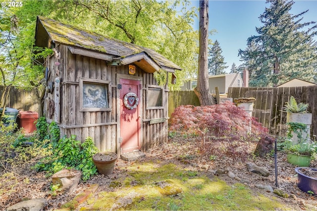 view of shed featuring fence