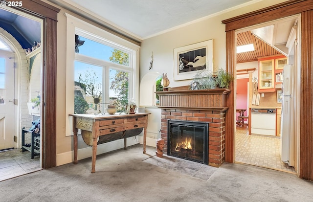 living area featuring carpet floors, crown molding, and a brick fireplace