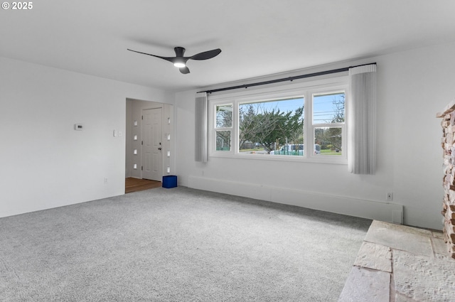 unfurnished room with carpet and a ceiling fan