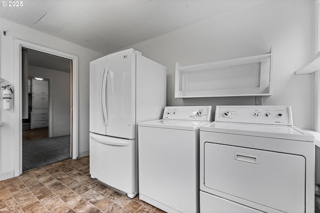 laundry area with laundry area, stone finish floor, and independent washer and dryer