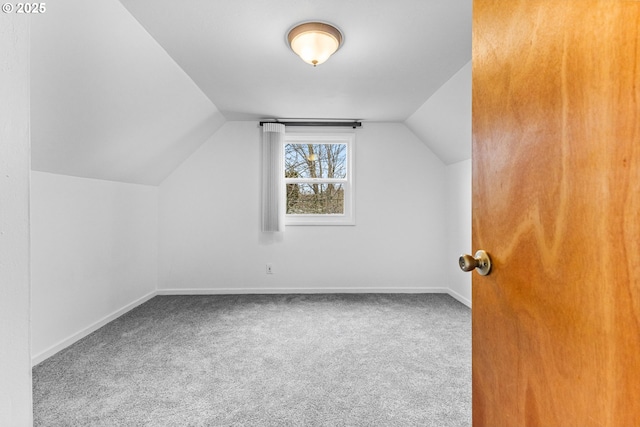 bonus room with baseboards, carpet flooring, and vaulted ceiling