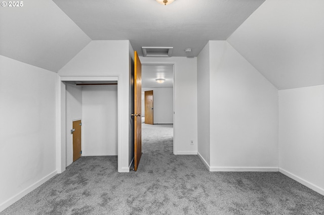 bonus room featuring baseboards, carpet floors, attic access, and vaulted ceiling