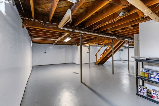 unfinished basement featuring stairs