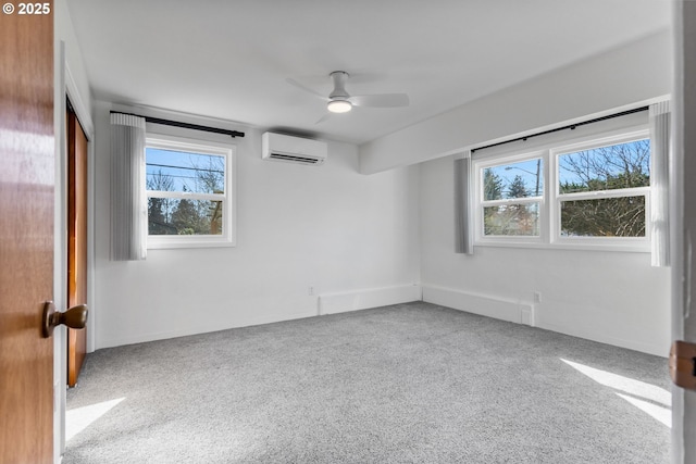 carpeted spare room with a ceiling fan and a wall unit AC