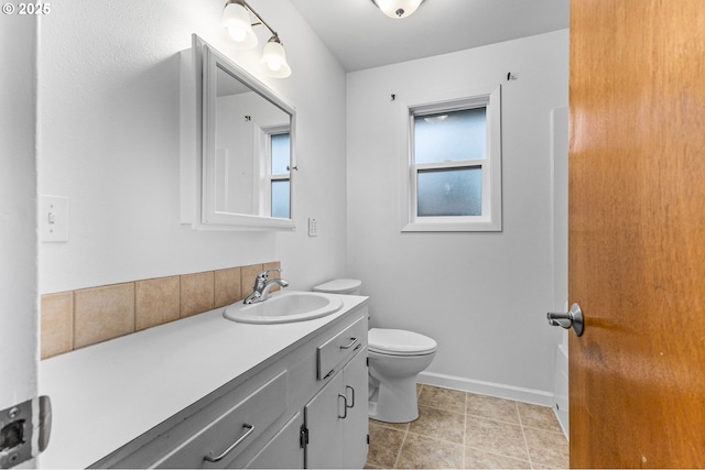 bathroom with vanity, tile patterned floors, toilet, and baseboards