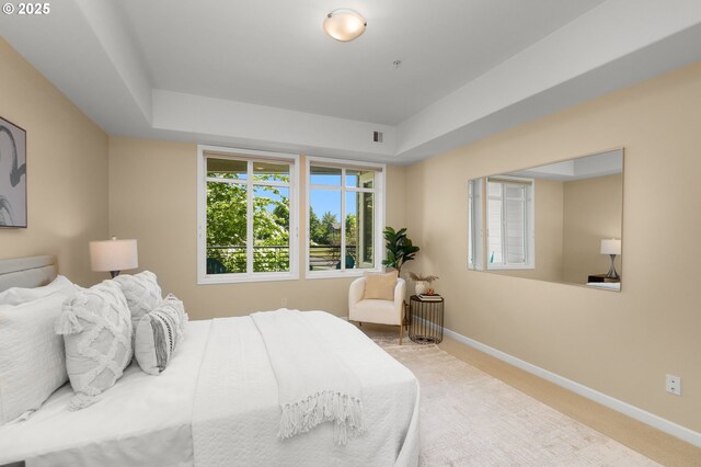 4873 NW Promenade Ter Unit 122, Portland, OR 97229 - carpeted bedroom with a raised ceiling and baseboards