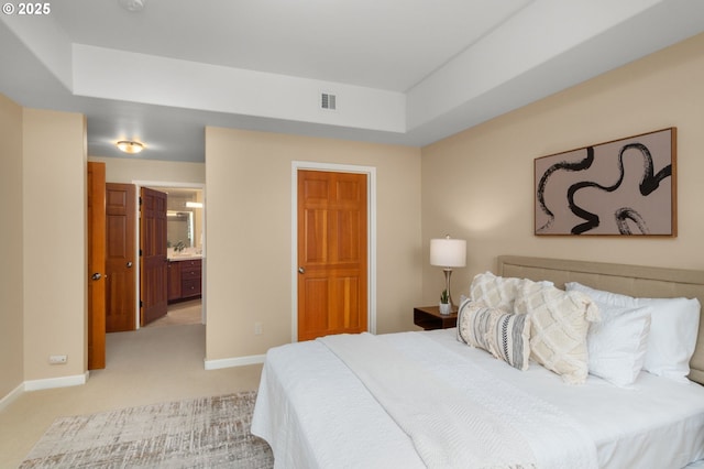4873 NW Promenade Ter Unit 122, Portland, OR 97229 - bedroom featuring light carpet, a raised ceiling, and ensuite bathroom