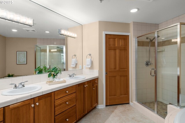 4873 NW Promenade Ter Unit 122, Portland, OR 97229 - full bathroom with a stall shower, double vanity, tile patterned floors, and recessed lighting