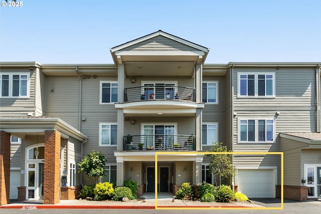 4873 NW Promenade Ter Unit 122, Portland, OR 97229 - view of front facade featuring a balcony, an attached garage, and asphalt driveway