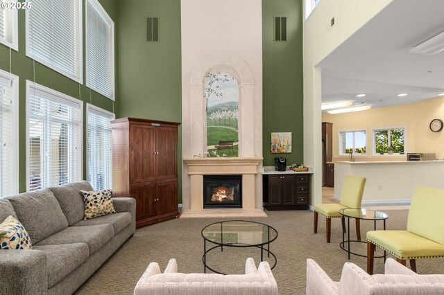 4873 NW Promenade Ter Unit 122, Portland, OR 97229 - carpeted living area with a high ceiling, plenty of natural light, a fireplace, and recessed lighting
