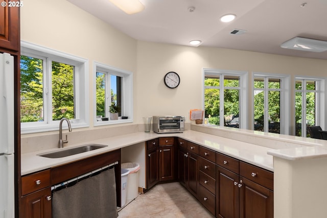 4873 NW Promenade Ter Unit 122, Portland, OR 97229 - kitchen featuring dishwashing machine, freestanding refrigerator, and light countertops
