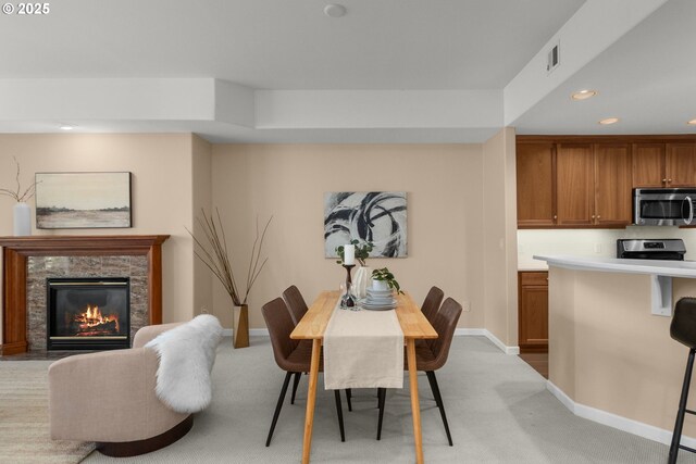4873 NW Promenade Ter Unit 122, Portland, OR 97229 - dining area featuring light carpet, recessed lighting, and a premium fireplace