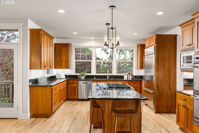 19375 SW Eastside Rd, Lake Oswego, OR 97034 - kitchen with built in appliances, light wood-style flooring, a chandelier, dark stone counters, and recessed lighting
