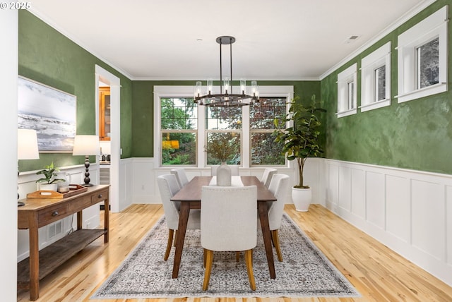 19375 SW Eastside Rd, Lake Oswego, OR 97034 - dining room featuring a decorative wall, wood finished floors, a chandelier, wainscoting, and crown molding