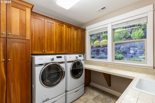 19375 SW Eastside Rd, Lake Oswego, OR 97034 - washroom with washing machine and clothes dryer, cabinet space, and baseboards