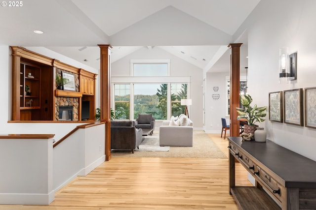 19375 SW Eastside Rd, Lake Oswego, OR 97034 - living room with ornate columns, light wood finished floors, high vaulted ceiling, baseboards, and recessed lighting