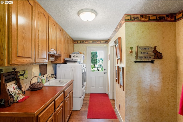 4269 Victor Point Rd, Silverton, OR 97381 - laundry room with cabinet space, a textured ceiling, wood finished floors, and independent washer and dryer