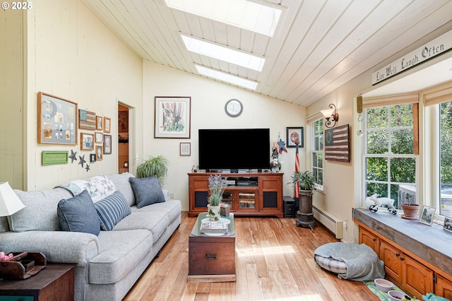 4269 Victor Point Rd, Silverton, OR 97381 - living area with a skylight, baseboard heating, vaulted ceiling, and light wood finished floors
