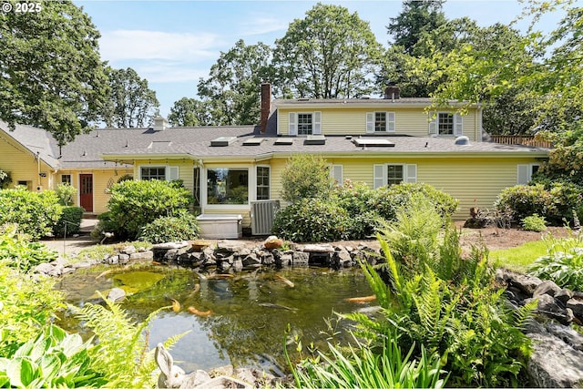 4269 Victor Point Rd, Silverton, OR 97381 - back of house featuring a garden pond and a chimney